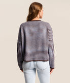 blue cardigan with dark brown horizontal stripes. button down closure. long sleeves 