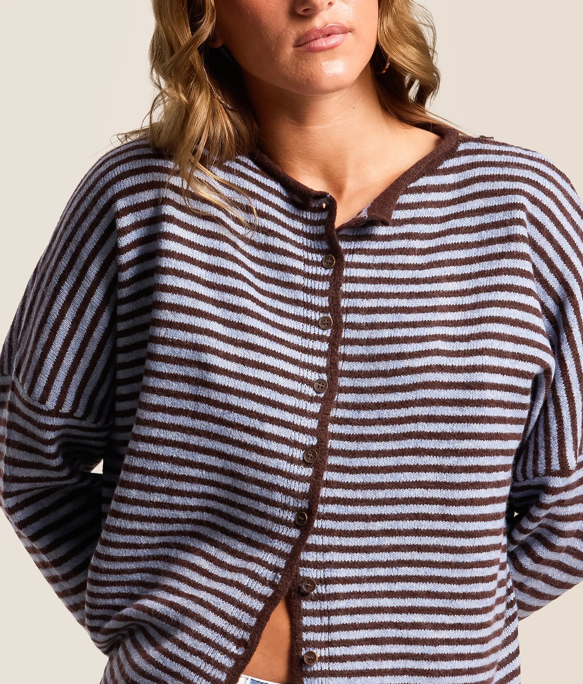 blue cardigan with dark brown horizontal stripes. button down closure. long sleeves 
