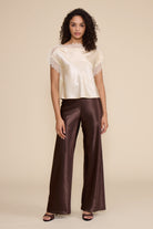 Lucy Paris Chris Lace Trim Top in ivory featuring a silky finish, relaxed fit, and delicate sheer lace trim along the neckline and short sleeves.