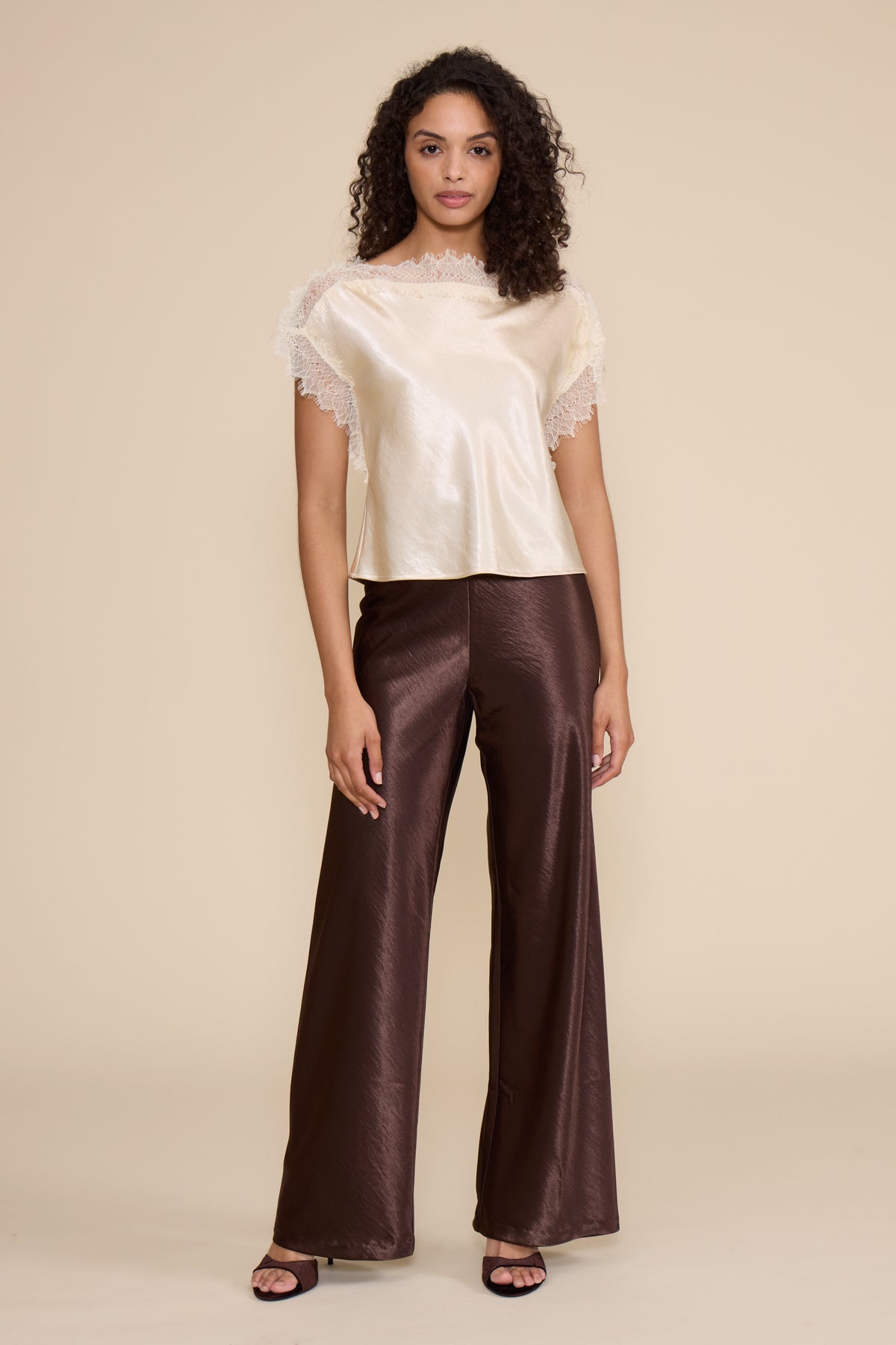 Lucy Paris Chris Lace Trim Top in ivory featuring a silky finish, relaxed fit, and delicate sheer lace trim along the neckline and short sleeves.