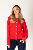 Neutral knit cardigan featuring a classic crew neckline, button-front closure, and ribbed detailing for a timeless, polished look.