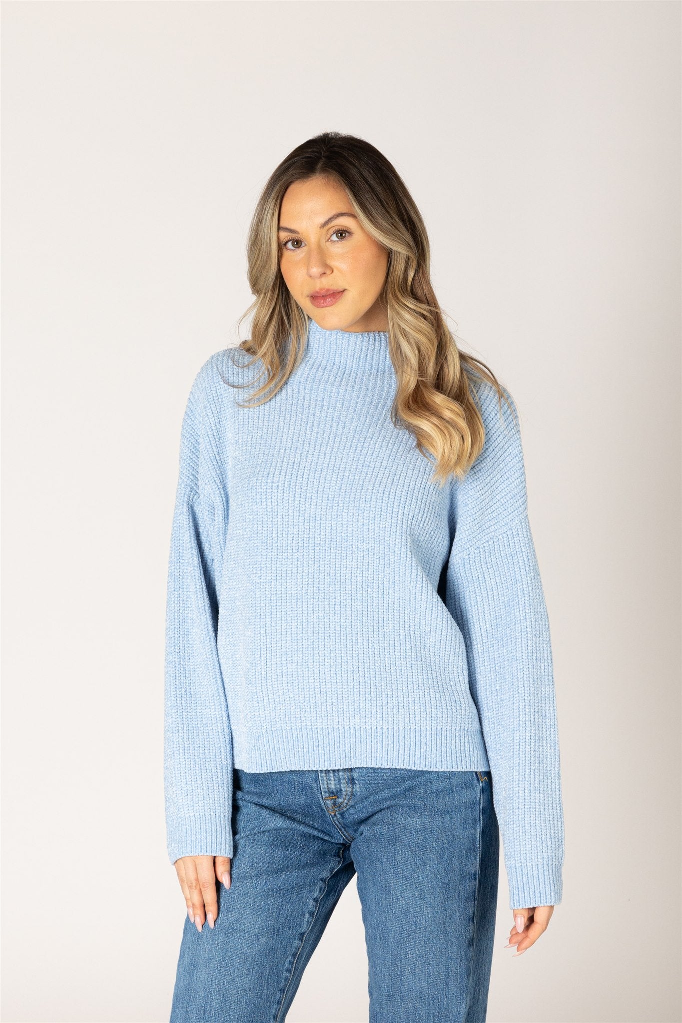 Sky blue ribbed knit sweater featuring a mock neckline, relaxed fit, and long sleeves.
