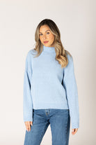 Sky blue ribbed knit sweater featuring a mock neckline, relaxed fit, and long sleeves.
