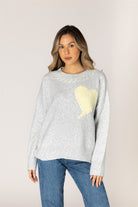 Ash grey crewneck sweater featuring a pale lemonade heart appliqué with contrast whipstitch detailing, long sleeves, and ribbed cuffs, hem, and neckline.