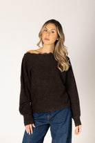 Knit lace sweater featuring an off-the-shoulder neckline, relaxed silhouette, and textured lace design in a neutral tone.