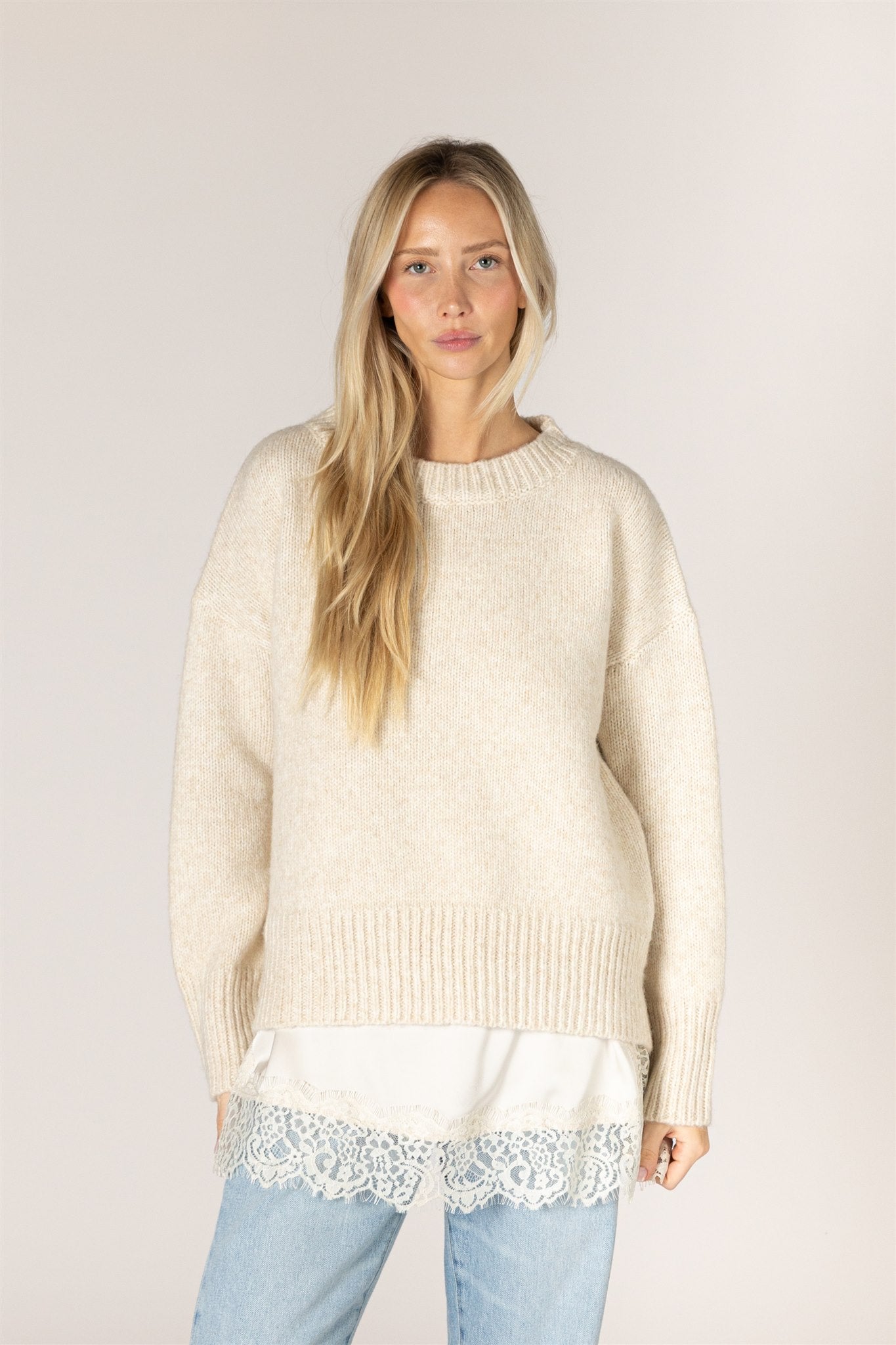 Pumice-colored Tanya sweater in a relaxed knit, featuring a classic crew neckline, dropped shoulders, long sleeves, and chunky ribbed trim at the neckline, cuffs, and hem.