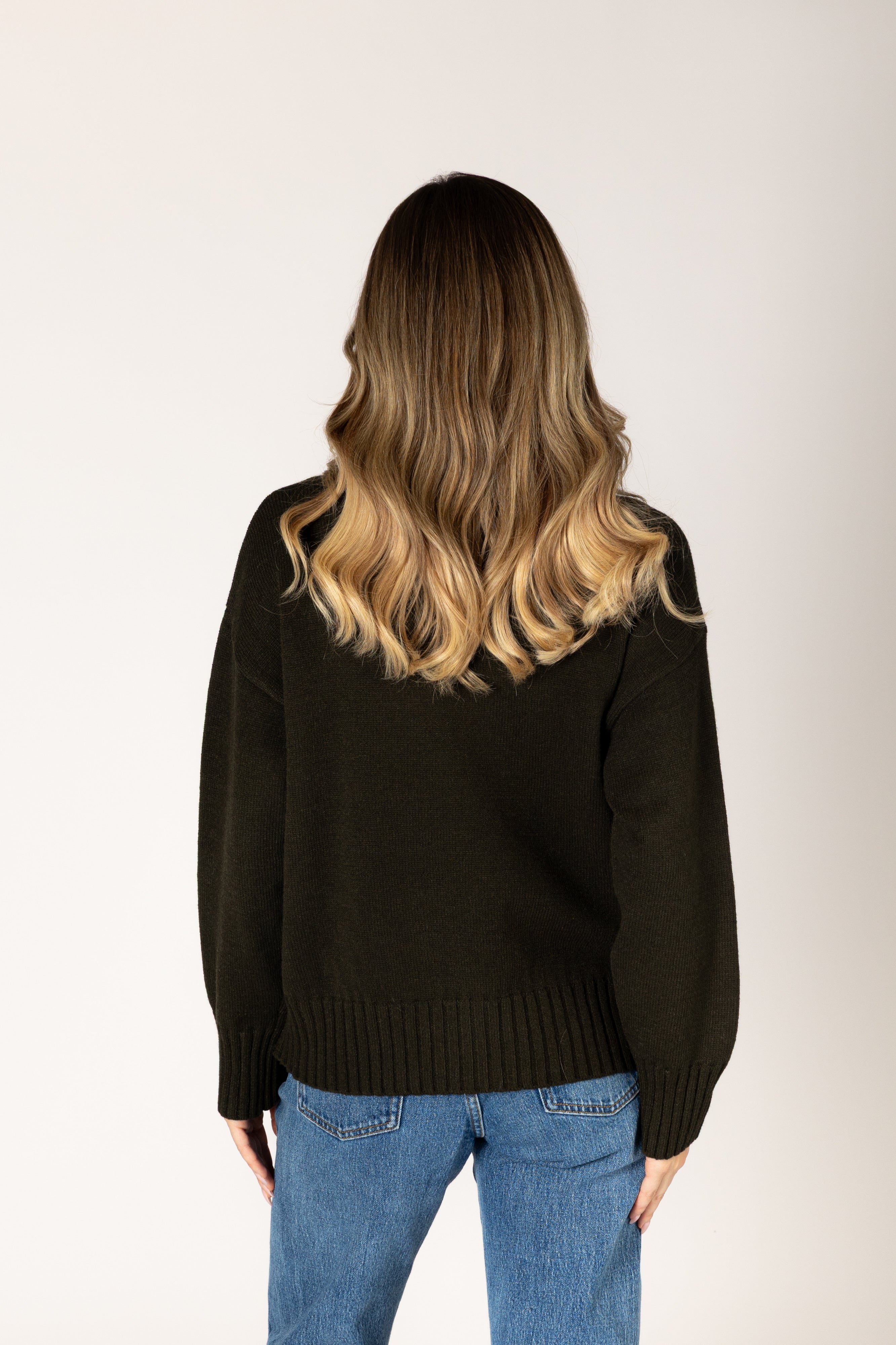 Olive crewneck sweater in a soft knit, featuring a classic silhouette and ribbed trim at the cuffs and hem.
