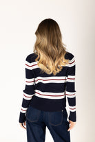 Lightweight ribbed knit cardigan in a navy base with white, brick red, and grey stripes, featuring a classic silhouette and button-front closure for easy layering.