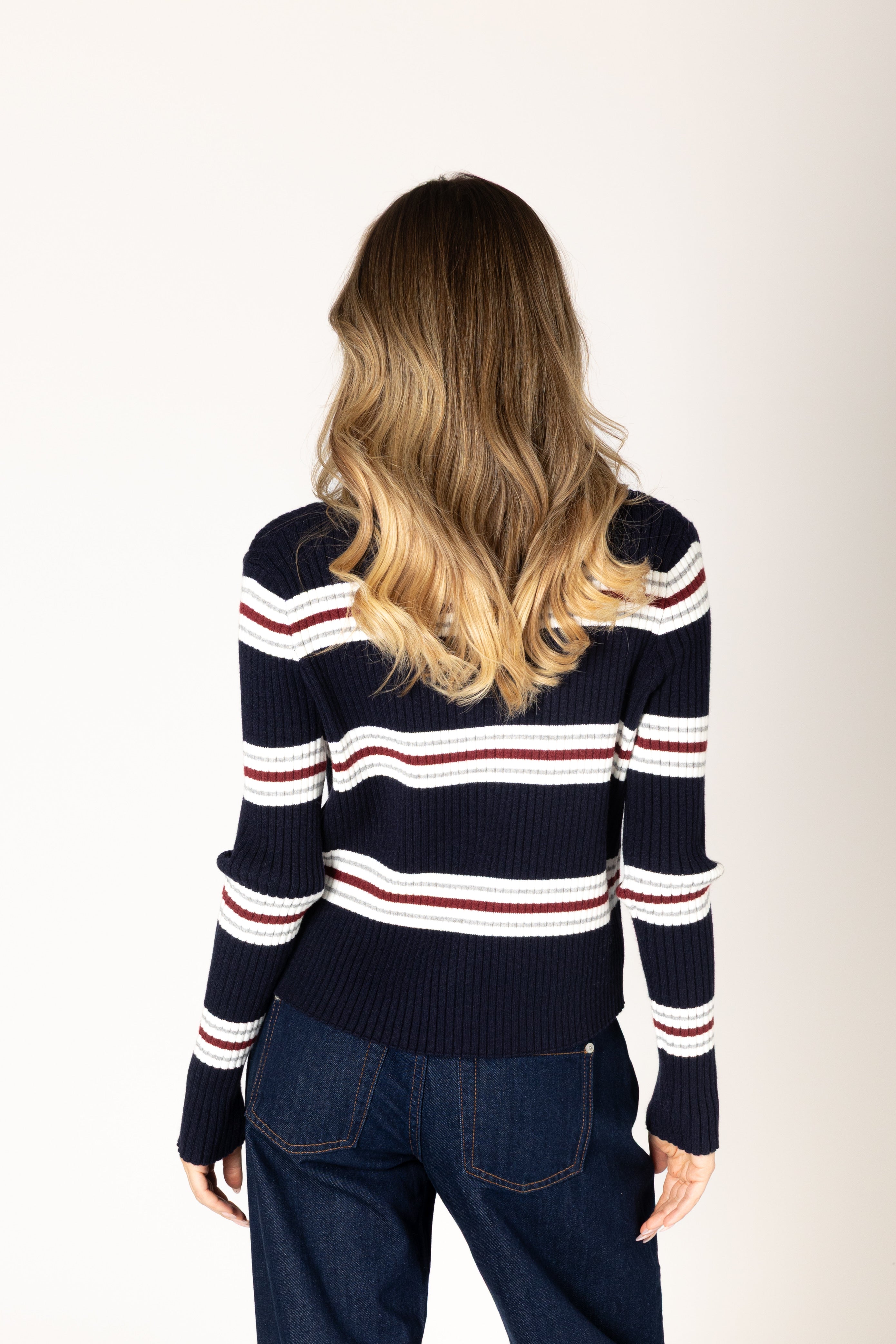 Lightweight ribbed knit cardigan in a navy base with white, brick red, and grey stripes, featuring a classic silhouette and button-front closure for easy layering.