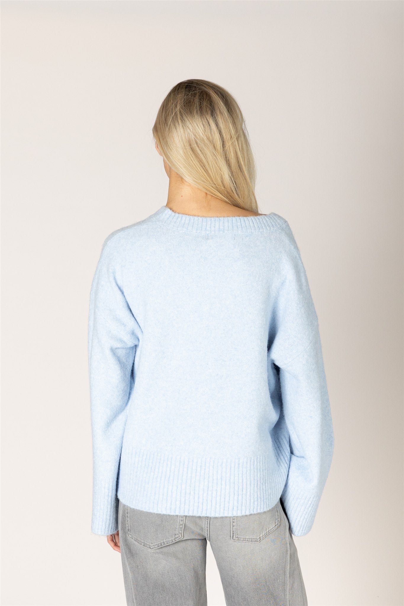 Breeze blue V-neck sweater in a lightweight knit, featuring a relaxed fit, long sleeves, and ribbed trim at the neckline, cuffs, and hem.