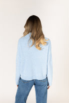 Sky blue ribbed knit sweater featuring a mock neckline, relaxed fit, and long sleeves.
