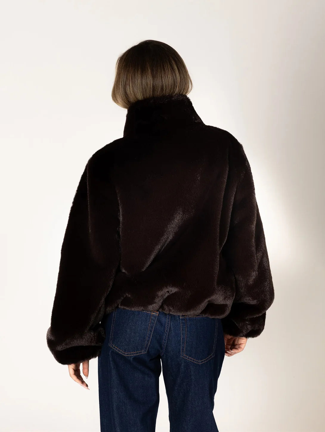 Kendra Short Faux Fur Coat in espresso brown featuring a soft, plush faux fur texture, relaxed fit, cropped silhouette, crew neckline, long sleeves, and front button closure.