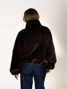 Kendra Short Faux Fur Coat in espresso brown featuring a soft, plush faux fur texture, relaxed fit, cropped silhouette, crew neckline, long sleeves, and front button closure.