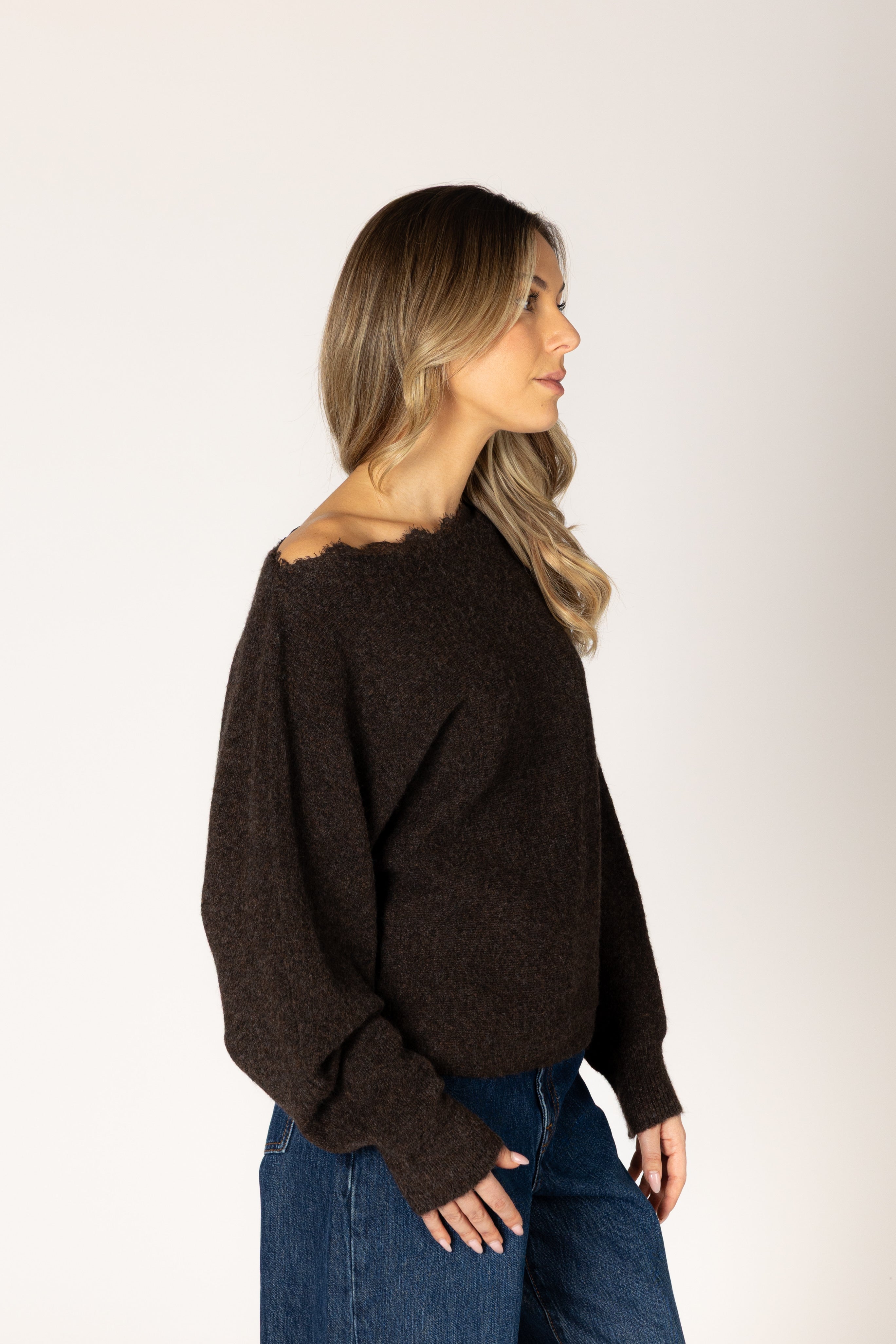 Knit lace sweater featuring an off-the-shoulder neckline, relaxed silhouette, and textured lace design in a neutral tone.