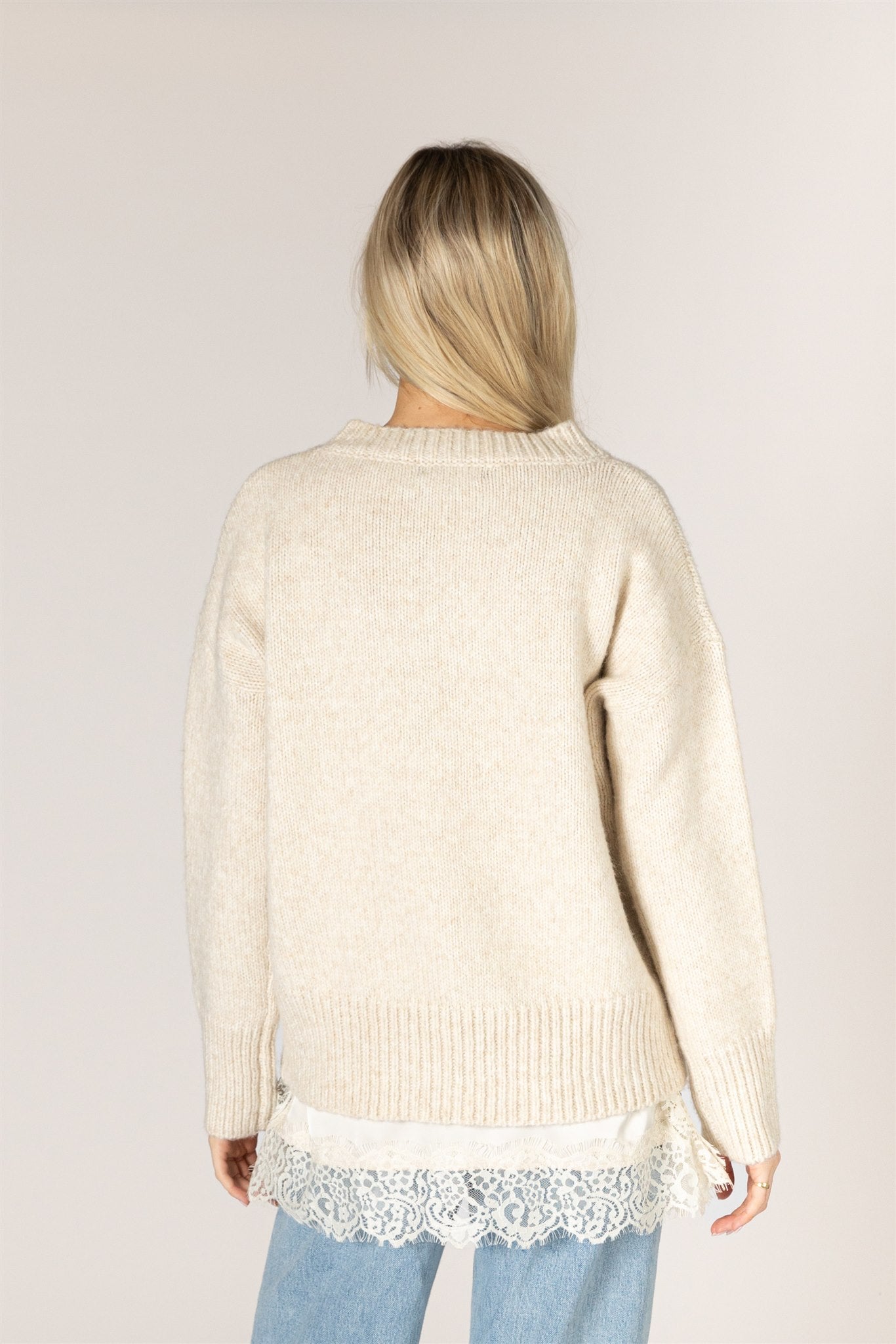 Pumice-colored Tanya sweater in a relaxed knit, featuring a classic crew neckline, dropped shoulders, long sleeves, and chunky ribbed trim at the neckline, cuffs, and hem.