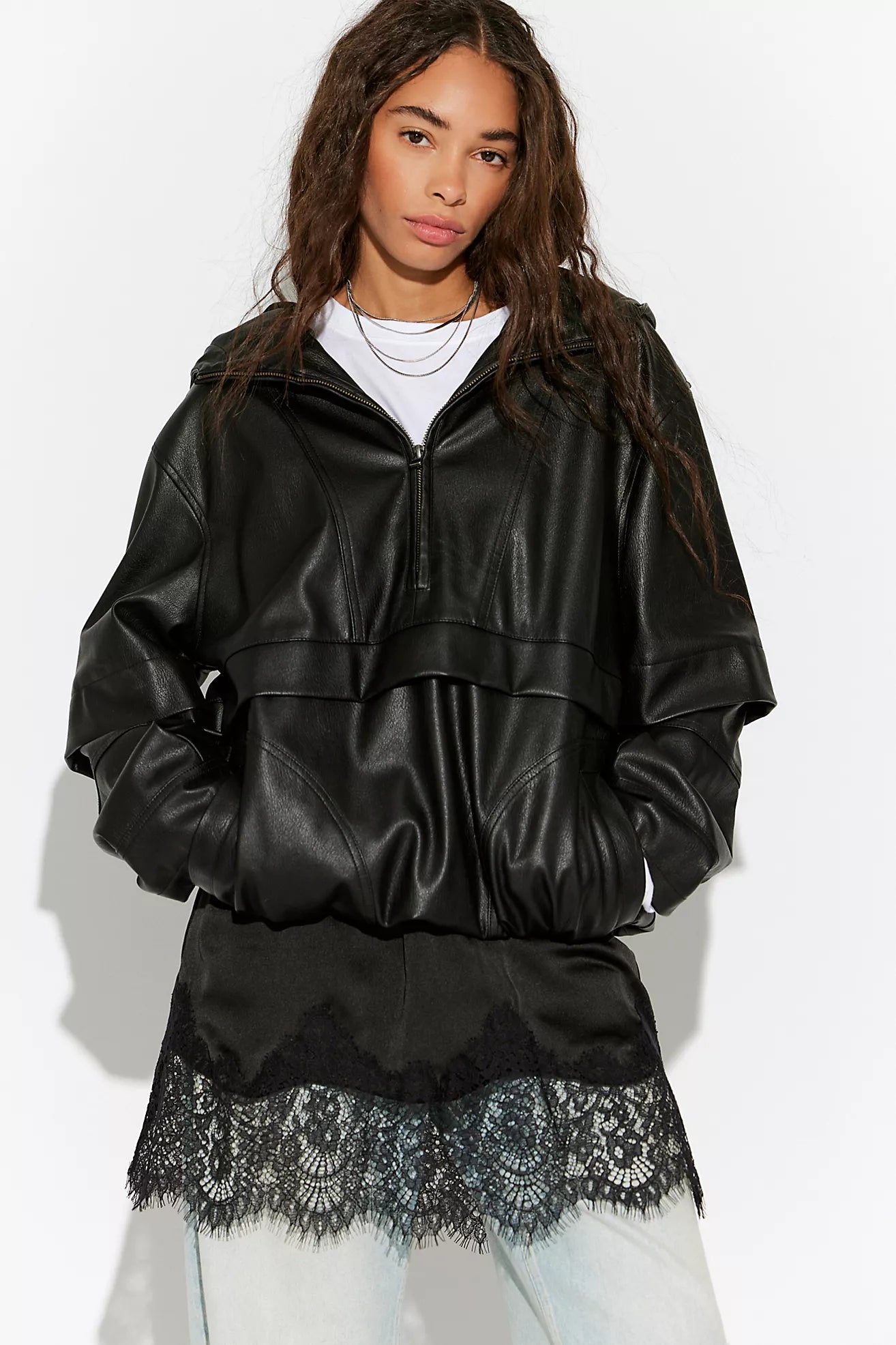 Free People Meet Me in the Middle Mini Slip Skirt in Black featuring a sleek satin finish, high-rise elastic waistband, bias-cut silhouette, and a flattering mini length.