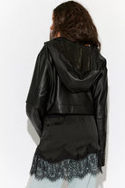 Free People Meet Me in the Middle Mini Slip Skirt in Black featuring a sleek satin finish, high-rise elastic waistband, bias-cut silhouette, and a flattering mini length.
