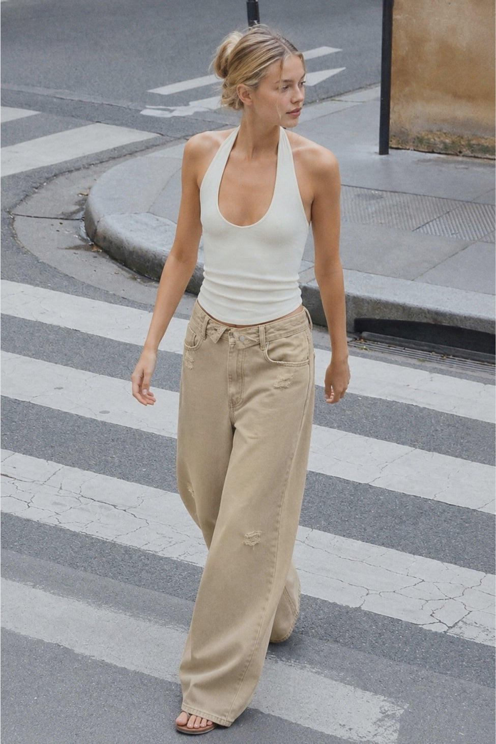 The Celine Folded-Waist Jeans in a soft sand wash, featuring a relaxed baggy wide-leg fit, folded waist detail, and subtle distressed accents.
