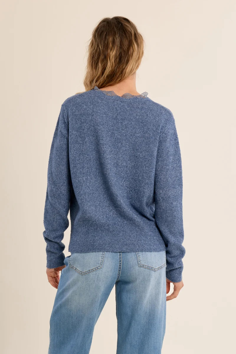 Short knit cardigan featuring long sleeves, a lace-trimmed V-neckline, and a full-length front button closure.