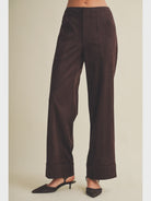 High-waisted faux suede pants with a slim wide-leg silhouette, pintuck detailing, full length, and wide cuffed hems. Model is 5'9" and wearing a size Small.