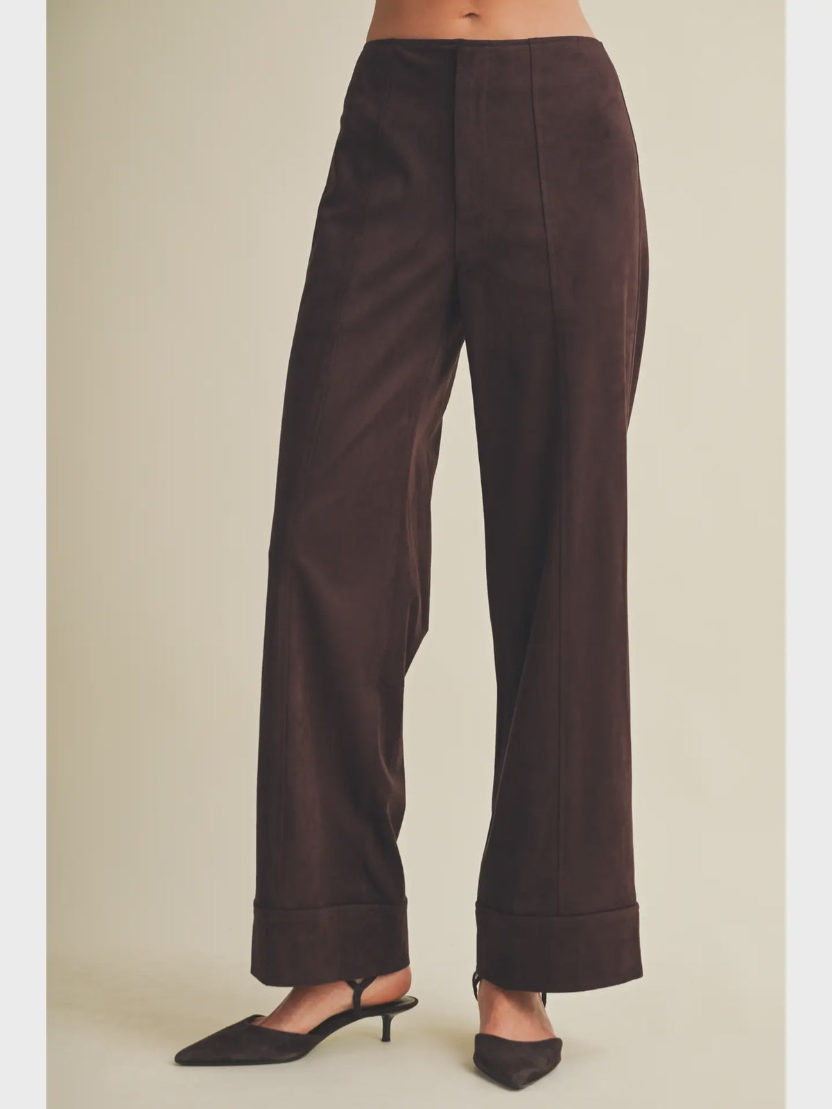 High-waisted faux suede pants with a slim wide-leg silhouette, pintuck detailing, full length, and wide cuffed hems. Model is 5'9" and wearing a size Small.