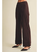 High-waisted faux suede pants with a slim wide-leg silhouette, pintuck detailing, full length, and wide cuffed hems. Model is 5'9" and wearing a size Small.