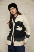 Mallard Zip-Up Cardigan in an ivory and black knit with a contrasting duck motif, collared neckline, button-front closure, long sleeves, and a relaxed fit with patterned detailing throughout.