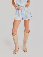 woman wearing blue checkered gingham shorts