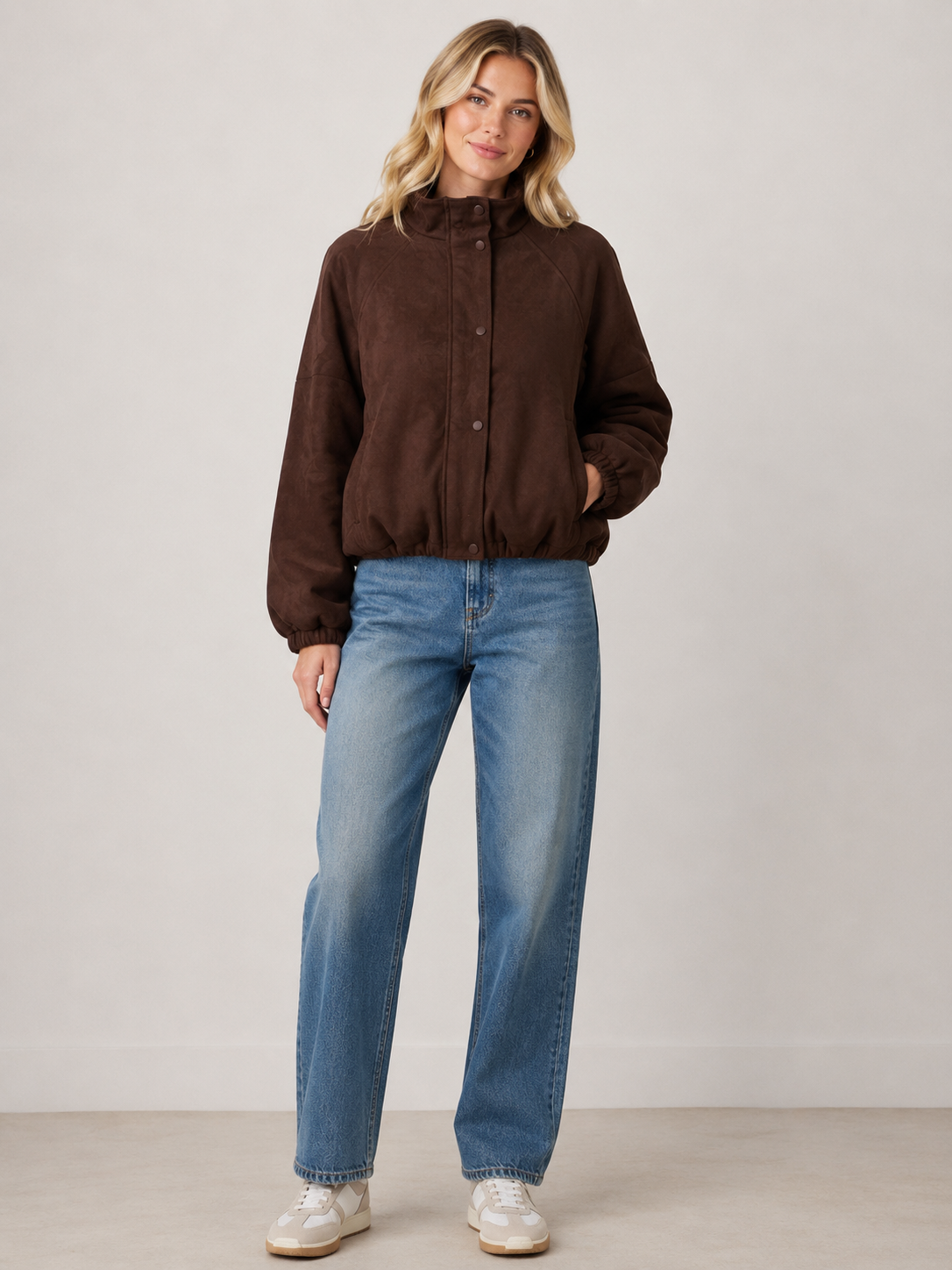 Chocolate brown faux suede bomber jacket featuring a relaxed fit, high funnel neckline, snap-button front closure, elasticated cuffs and hem, and functional side pockets for a polished everyday layering piece.

