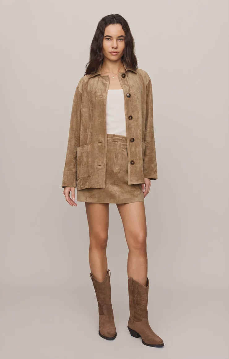Faux suede statement coat with a relaxed silhouette, classic collar, long sleeves, button-front closure, and roomy patch pockets. Finished in a soft, midweight fabric for an elevated everyday layer.