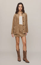 Faux suede statement coat with a relaxed silhouette, classic collar, long sleeves, button-front closure, and roomy patch pockets. Finished in a soft, midweight fabric for an elevated everyday layer.
