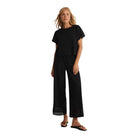 woman wearinng black straight leg ankle length pant with detailing at the bottom 