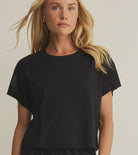 woman wearing black short sleeve top with crochet detailing on the sleeves