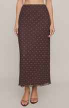 Brown mesh midi skirt with white polka dots, featuring a high-rise elastic waistband, lettuce-edge hem, and fully lined silhouette.
