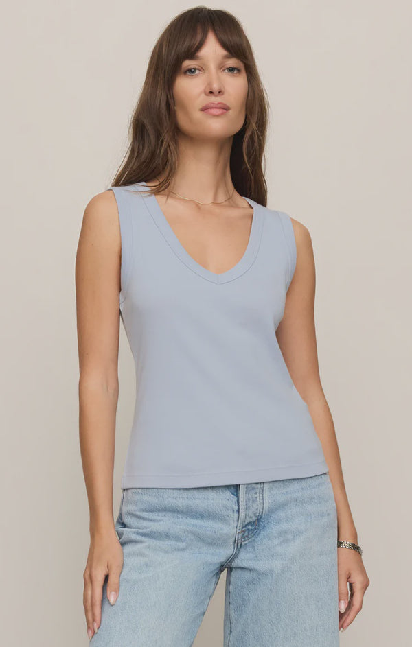 Model wearing the Z Supply Ellie V-Neck Tank, a sleeveless ribbed cotton tank featuring a flattering V-neckline, wide bra-friendly straps, and a fitted silhouette. The versatile essential is styled with casual bottoms for an effortless everyday look.