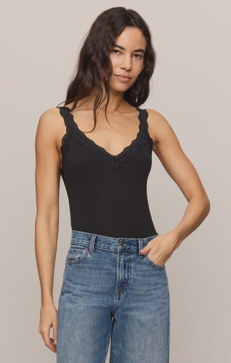 Fitted baby rib cotton tank with a lace-trimmed V-neckline and wide straps. A soft, feminine essential that's perfect for layering or wearing on its own.