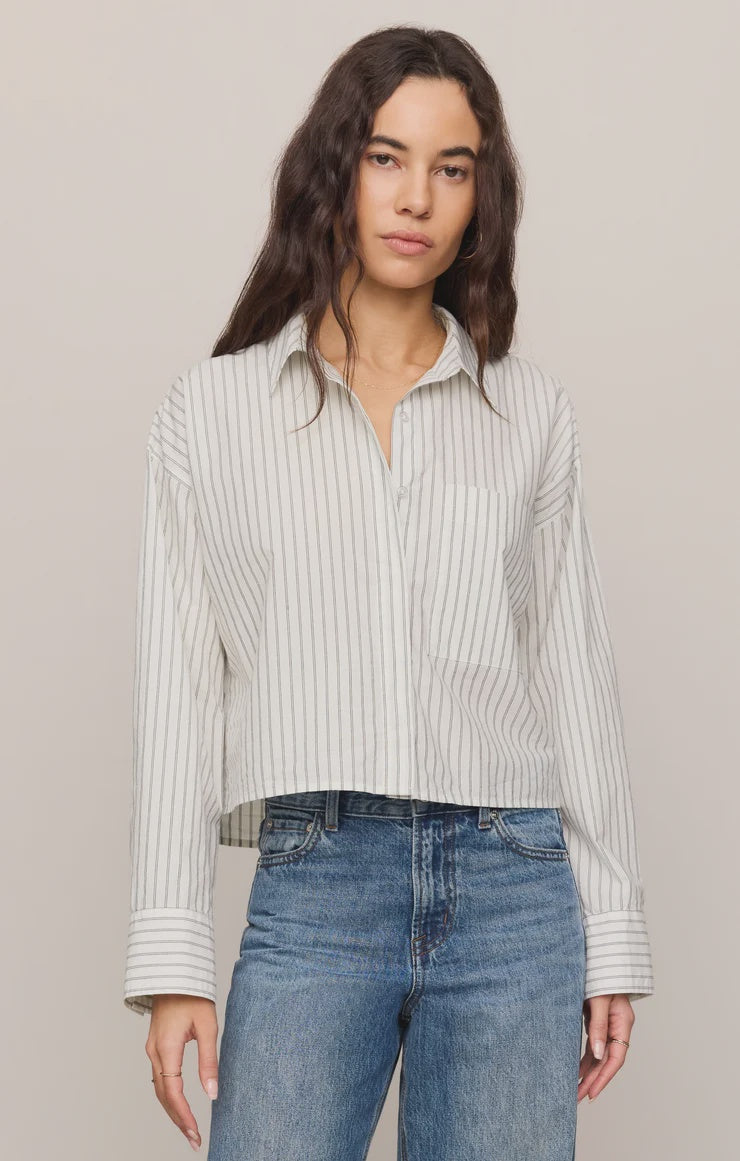 Striped long-sleeve button-up shirt in lightweight cotton poplin with a classic collar, chest pocket, and structured silhouette. Designed with a slightly shorter length for a modern fit, this polished everyday essential features a timeless striped pattern and crisp cotton fabrication.
