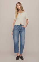 Vintage-wash blue mid-rise jeans featuring a relaxed bowed-leg silhouette, ankle-length hem, and classic five-pocket styling.
