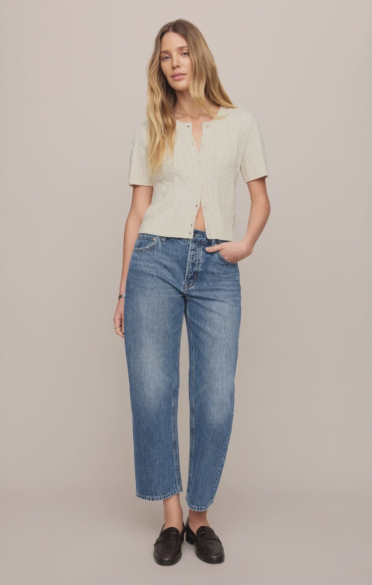 Vintage-wash blue mid-rise jeans featuring a relaxed bowed-leg silhouette, ankle-length hem, and classic five-pocket styling.

