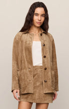 Faux suede statement coat with a relaxed silhouette, classic collar, long sleeves, button-front closure, and roomy patch pockets. Finished in a soft, midweight fabric for an elevated everyday layer.