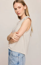 Relaxed muscle tee in soft cotton-blend jersey with gold metal grommet details at the arm openings. An elevated everyday basic with an effortless drape and versatile, modern silhouette.