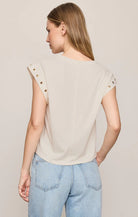Relaxed muscle tee in soft cotton-blend jersey with gold metal grommet details at the arm openings. An elevated everyday basic with an effortless drape and versatile, modern silhouette.