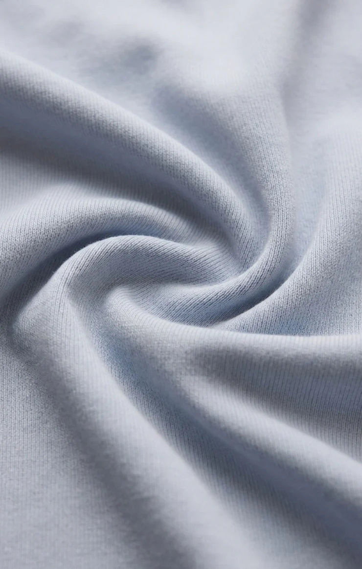 Close-up of the Z Supply Ellie V-Neck Tank's soft 100% cotton baby rib fabric, highlighting its fine ribbed texture, smooth finish, and comfortable stretch with a substantial yet breathable feel.
