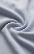 Close-up of the Z Supply Ellie V-Neck Tank's soft 100% cotton baby rib fabric, highlighting its fine ribbed texture, smooth finish, and comfortable stretch with a substantial yet breathable feel.