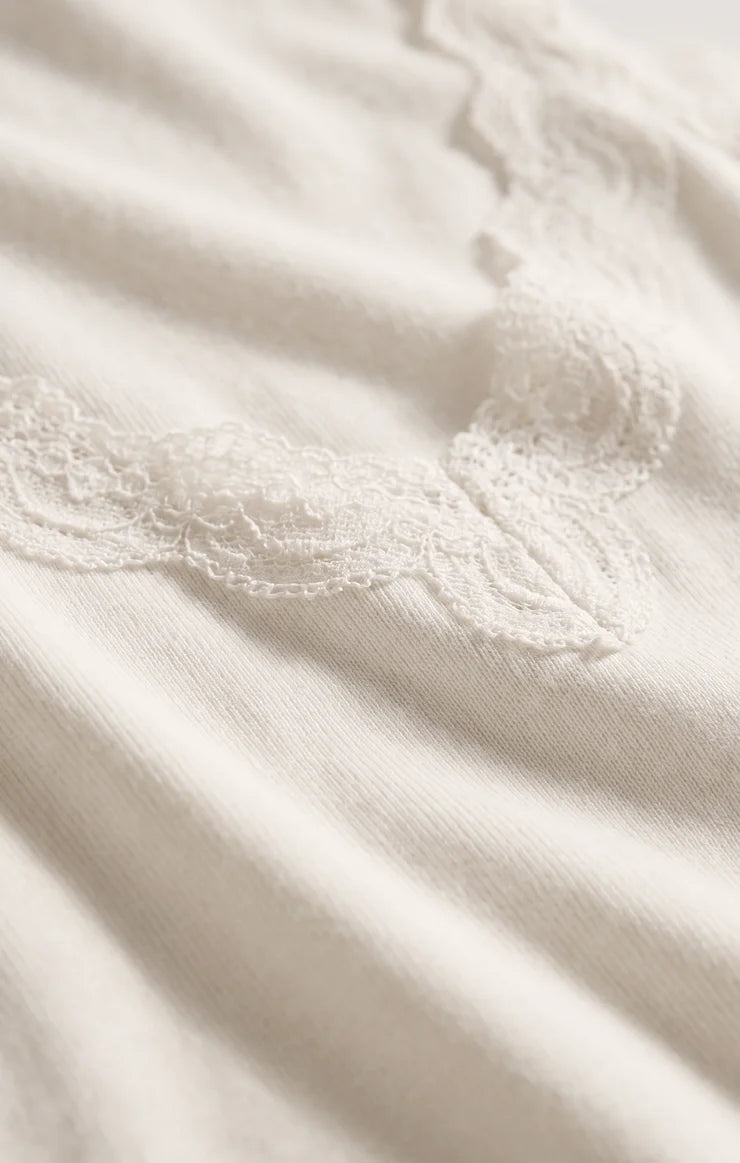 Fitted baby rib cotton tank with a lace-trimmed V-neckline and wide straps. A soft, feminine essential that's perfect for layering or wearing on its own.