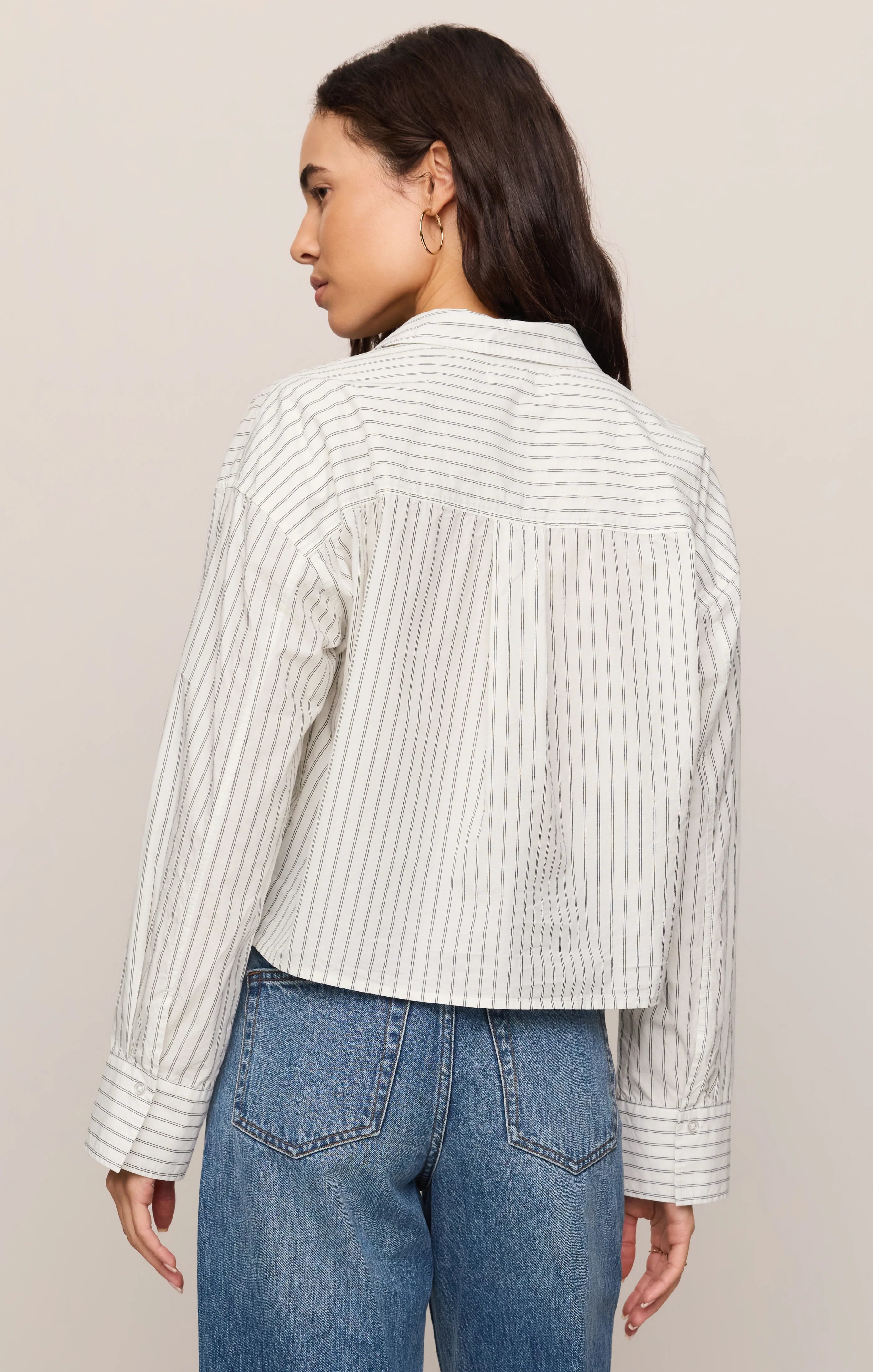 Striped long-sleeve button-up shirt in lightweight cotton poplin with a classic collar, chest pocket, and structured silhouette. Designed with a slightly shorter length for a modern fit, this polished everyday essential features a timeless striped pattern and crisp cotton fabrication.
