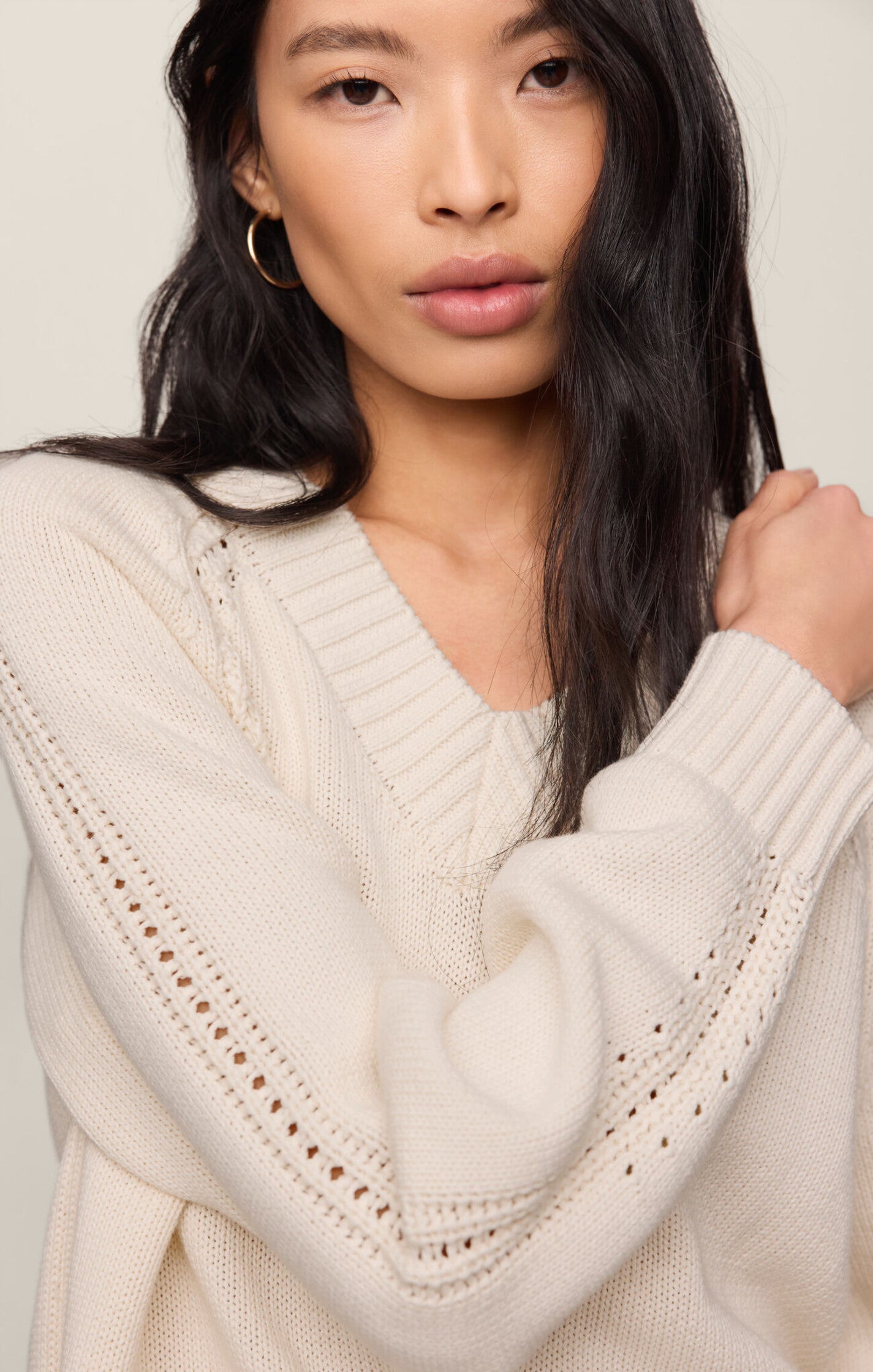 Model wearing the Z Supply Stratton V-Neck Sweater in Sandstone, featuring a V-neckline, long sleeves, and a soft cotton knit in a neutral beige hue.