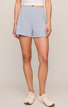 Soft baby French terry shorts featuring a high-rise fit, elastic waistband, sporty dolphin hem, and side seam pockets. Designed in a relaxed silhouette for comfortable everyday wear.