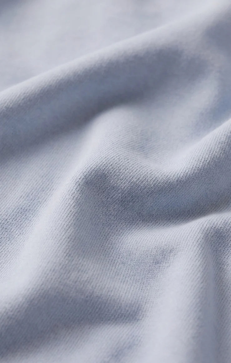 Close-up of the baby French terry fabric, showcasing its soft cotton-blend texture with a smooth exterior and plush looped interior for lightweight comfort.