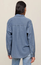 Relaxed-fit indigo cotton twill button-up shirt with a collared neckline, long sleeves, button-front closure, and a single chest pocket. Made from 100% cotton with a soft, drapey feel.